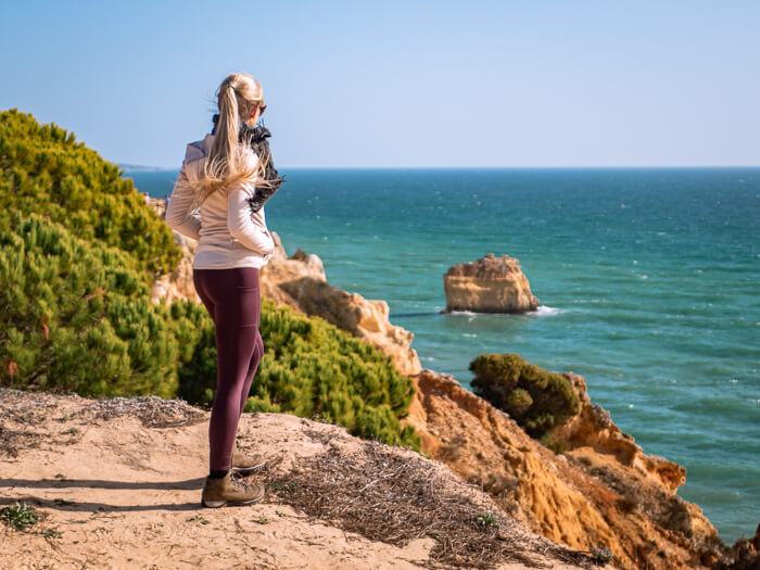 Me looking at the view over the golden cliffs and turquoise sea in Algarve