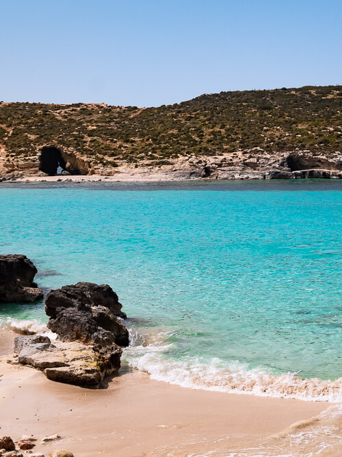 crystal blue water and a sandy beach at Blue Lagoon, one of the best places to visit in Malta