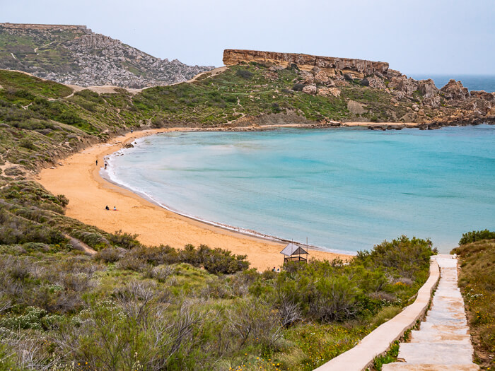 orange sand and turquoise sea at Ghajn Tuffieha Beach, a mandatory stop on every Malta road trip