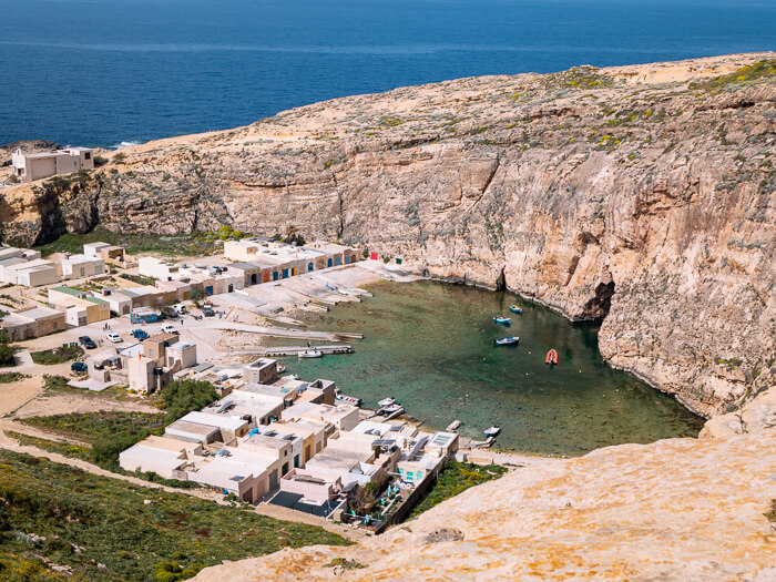 a small lagoon surrounded by white boathouses at Inland Sea, one of the most unique spots to add to your Malta itinerary