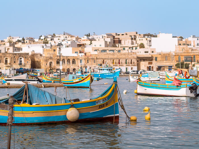 Colorful Maltese fishing boats at the harbor of Marsaxlokk village on the south coast of Malta