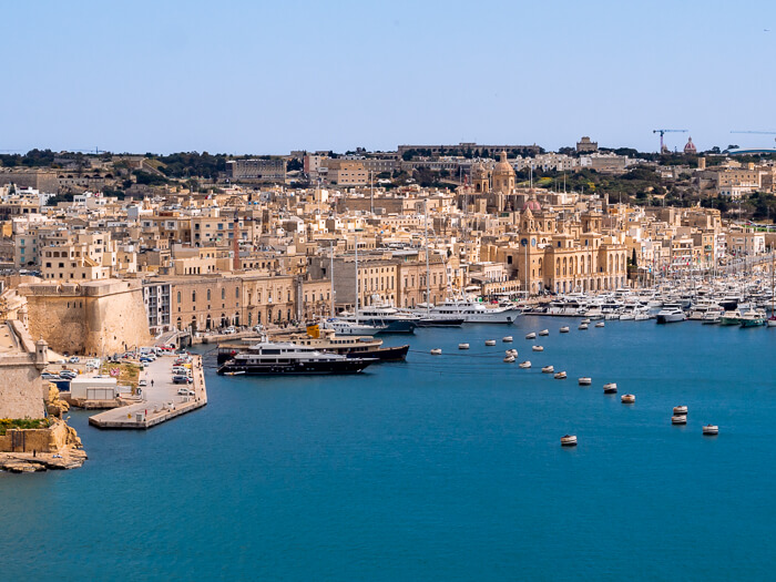 yachts parked at the Grand Harbor with a backdrop of Vittoriosa town near Valletta