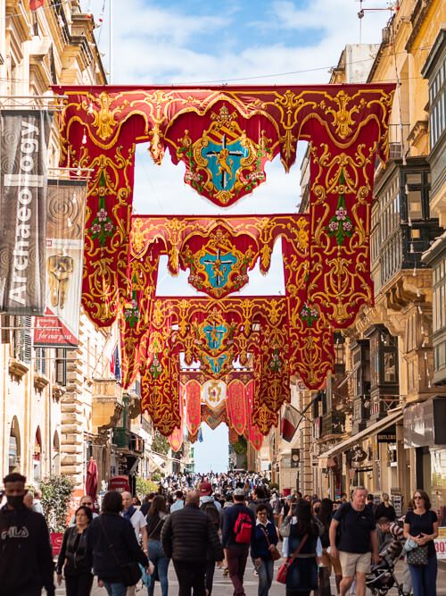 colorful flags above the bustling Republic Street, the main street in Valletta