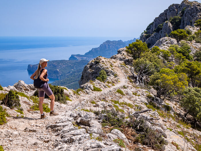 A woman hiking along the rocky Archduke's Trail, one of the best hikes in Mallorca