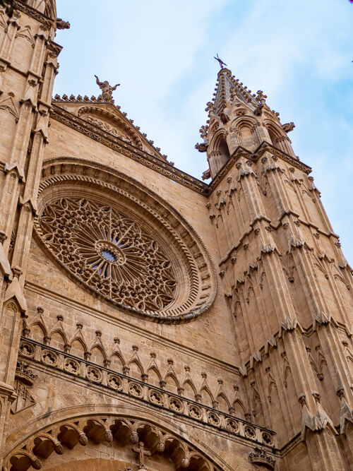 The intricate facade of the gothic La Seu Cathedral in Palma de Mallorca.
