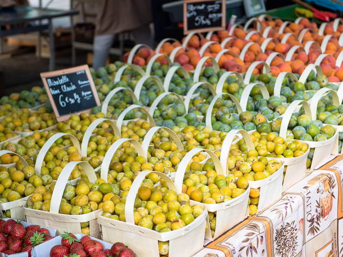 A variety of colorful fruits arranged in baskets at Chamonix Saturday market