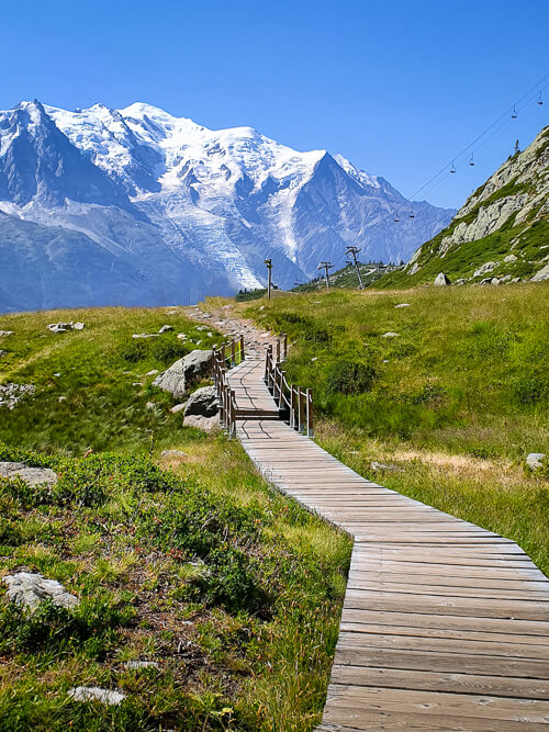 A view of a boardwalk and Mont Blanc on the Lac Blanc hike, one of the best things to do in Chamonix