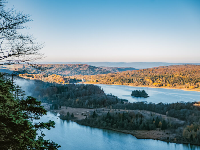 A view over the Quatre Lacs lakes nestled in forest-covered hills in the Jura region in France 