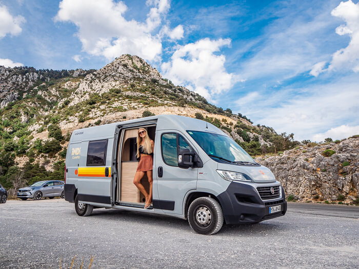 A woman looking out of a campervan at the Route des Cretes Verdon road in France