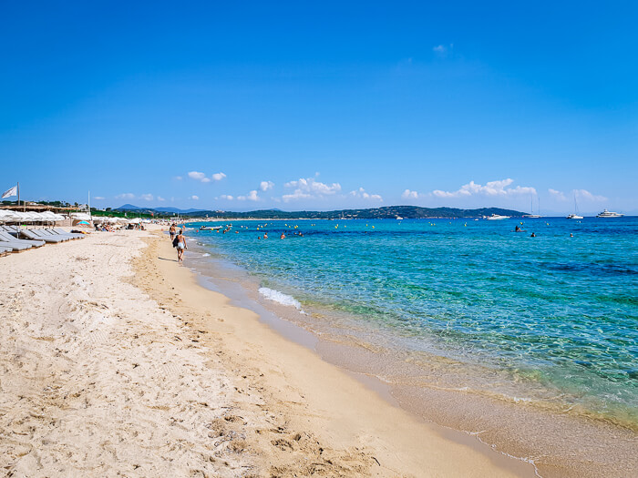 Fine sand and crystal clear water at Pampelonne Beach near Saint-Tropez on a sunny summer day.