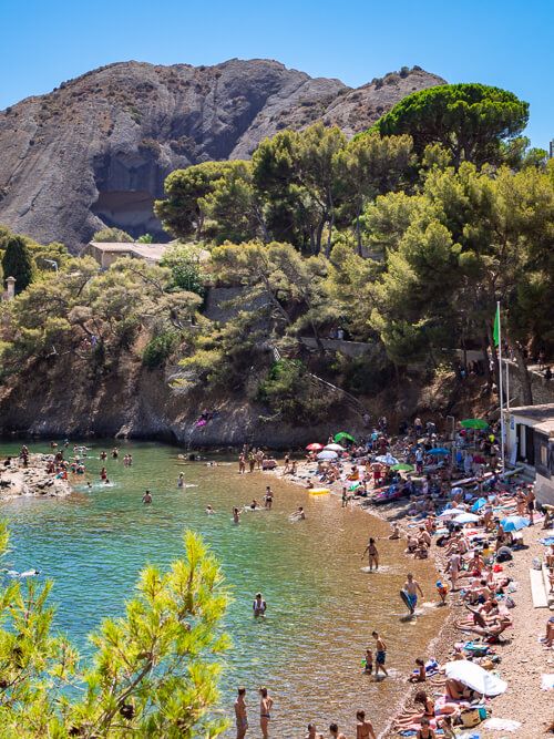 The small pebbly Grand Mugel beach surrounded by tall rocks, one of the most unique beaches in this 5-day South of France itinerary 