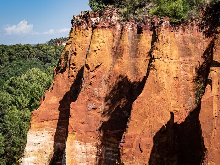 A cliff in various shades of orange on the Ochre Trail near Roussillon village in Provence.