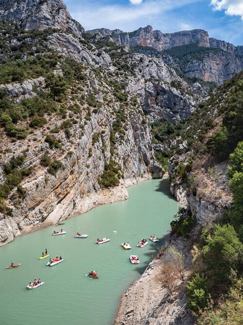 Small boats sailing on the calm waters of Verdon Gorge, one of the top places to visit on a Provence road trip