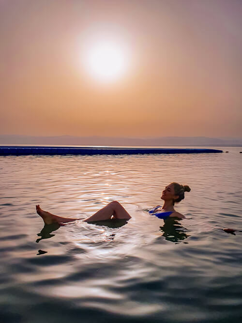 Me floating in the Dead Sea in Jordan at sunset