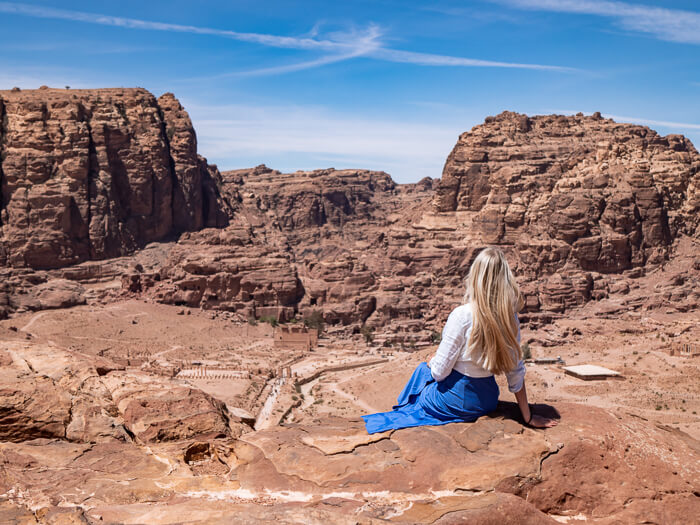 Me sitting on a rock overlooking the archaeological site of Petra