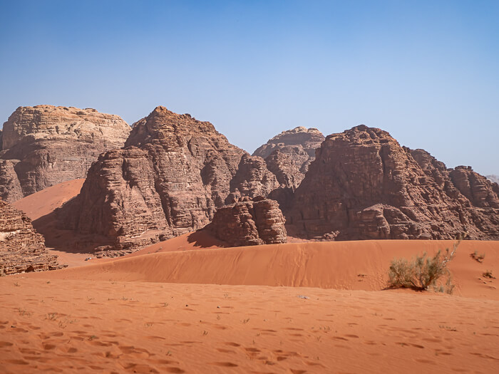 Mars-like desert landscape with orange dunes and rugged mountains in Jordan