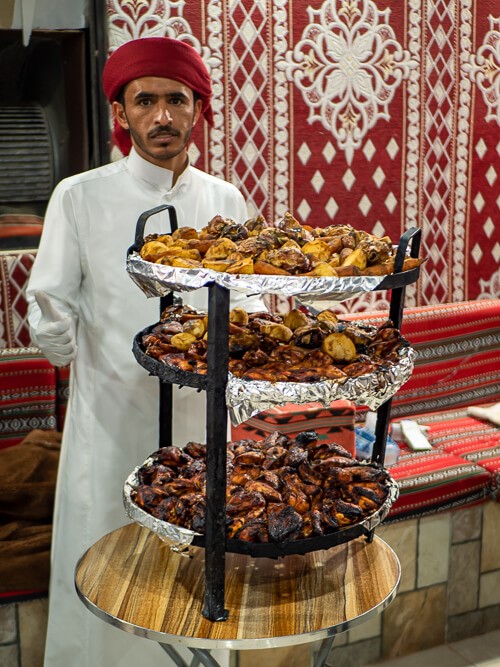 A man serving a traditional Bedouin dinner Zarb in a desert camp in Jordan