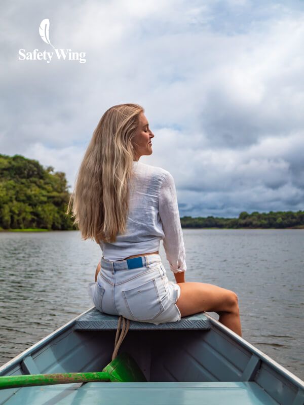 Me sitting at the front of a boat cruising on a river in the Amazon jungle in Brazil.