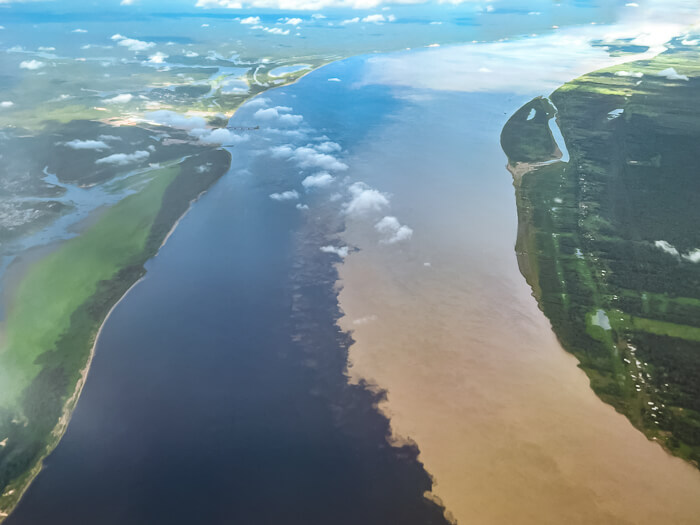 An aerial view of the Meeting of the Waters, an area where two rivers meet to form the Amazon River