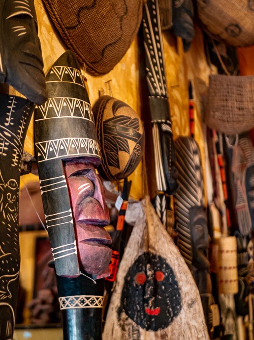 a variety of decorative wooden masks created by indigenous communities of the Amazon region
