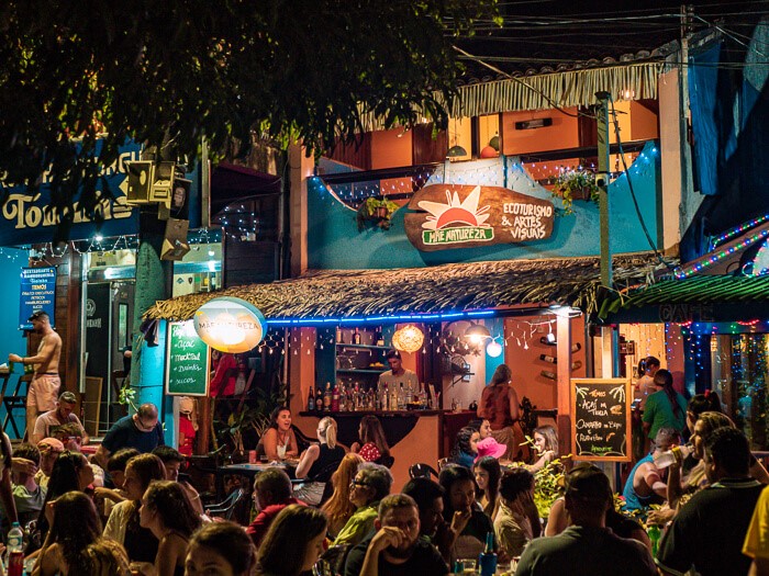 Colorful outdoor restaurants full of people at the main square of Alter do Chao, Brazil