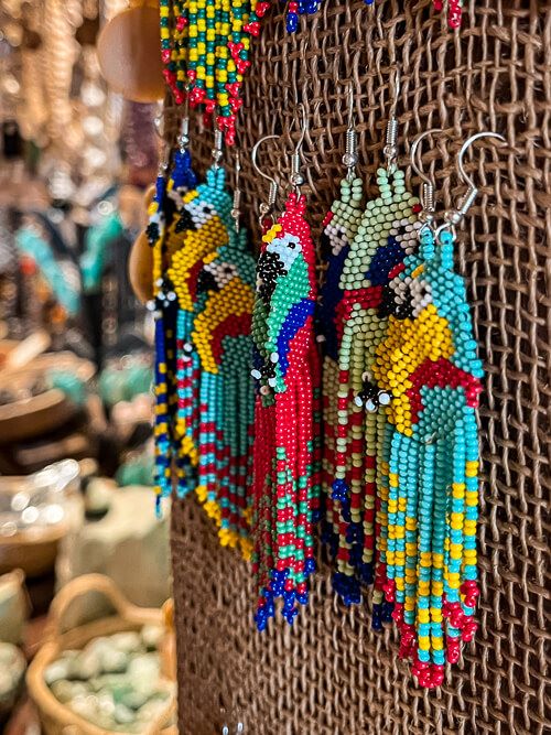 colorful earrings made of small pearls in the shape of parrots