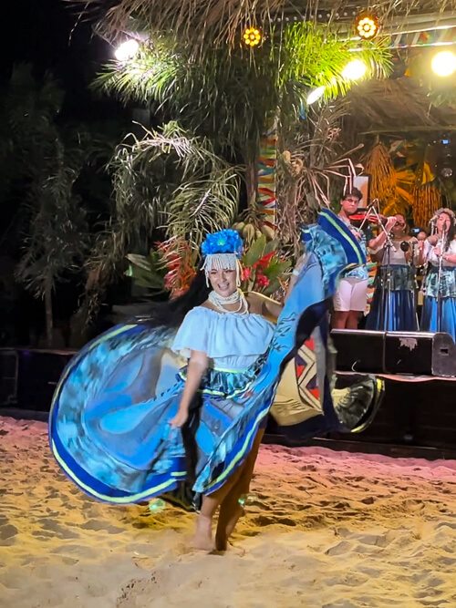 a woman in a traditional outfit performing Carimbo dance in Alter do Chao