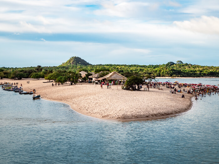 a sandy peninsula known as Ilha do Amor with a backdrop of lush rainforest in Alter do Chao, Brazil