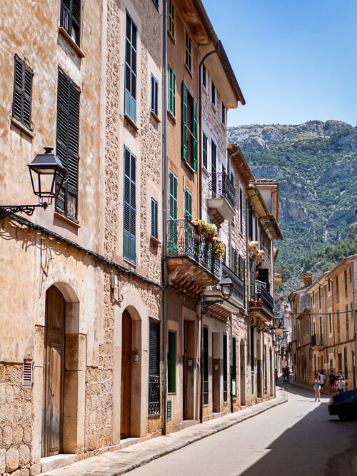 Traditional stone houses with flower-adorned balconies in Soller.
