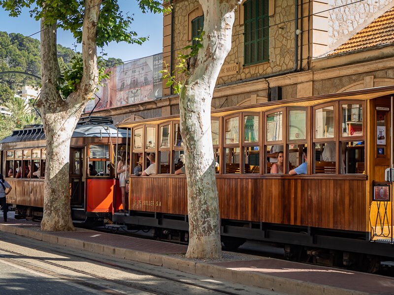 Tourists riding the vintage wooden Soller tram, one of the best things to do in Soller