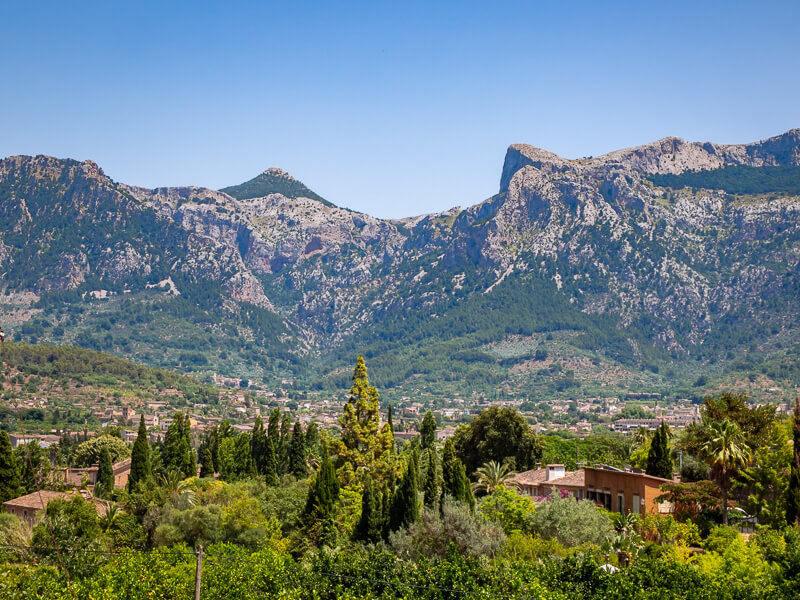 green vegetation and the towering peaks of the Tramuntana mountains around Soller, Mallorca