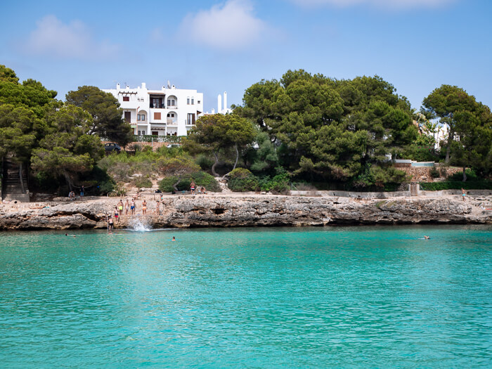 Bright blue waters at Cala Gran beach, one of the best areas to stay in Cala d'Or, Mallorca