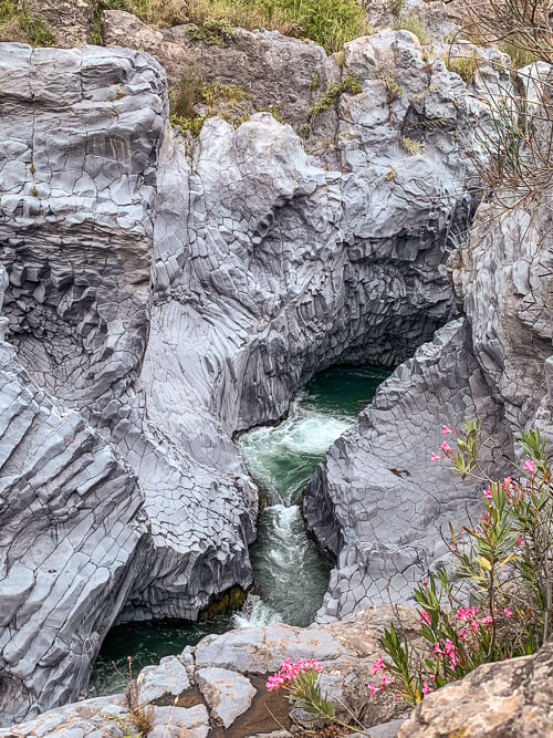 Grey volcanic rock walls of Alcantara Gorge near Mount Etna