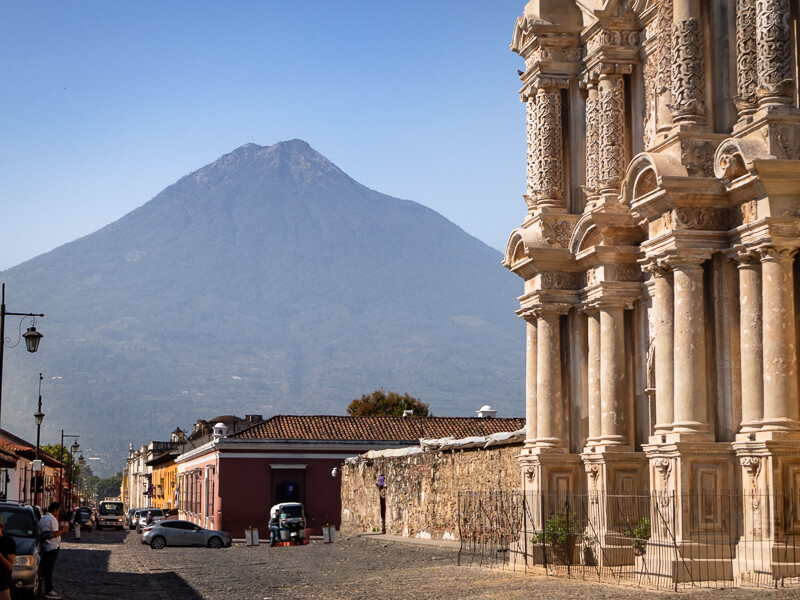 Old church ruins with a backdrop of the looming Agua volcano in Antigua Guatemala