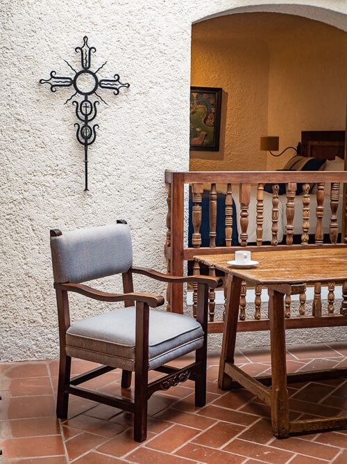 a chair and an antique wooden coffee table