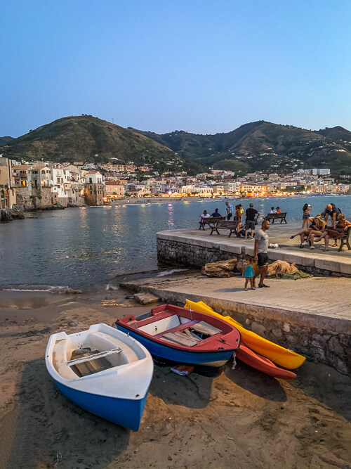 Colorful boats at a beach in Cefalu, a medieval town that should be a part of every Sicily itinerary.