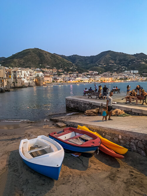 Colorful boats on the beach in Cefalu, a medieval town in Sicily.