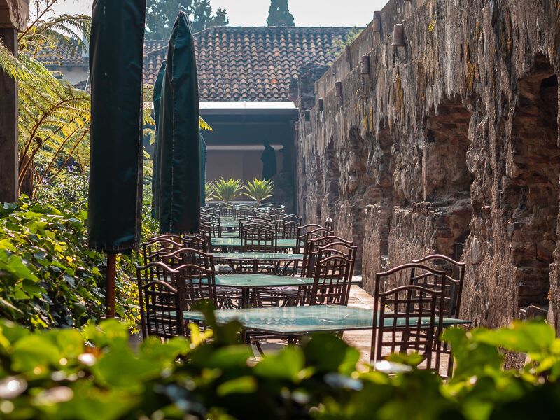 a row of tables and chairs in a garden