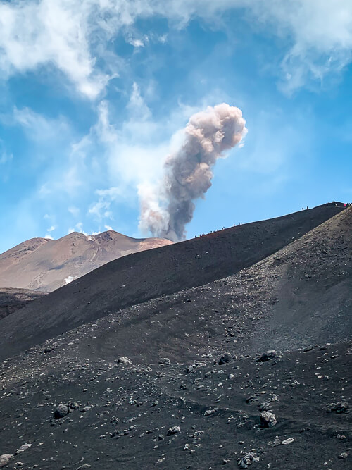 Ash columns and smoke rising from the crater of Mount Etna volcano