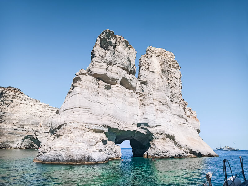 White towering cliffs rising out of emerald waters in Kleftiko Bay on Milos island, Greece