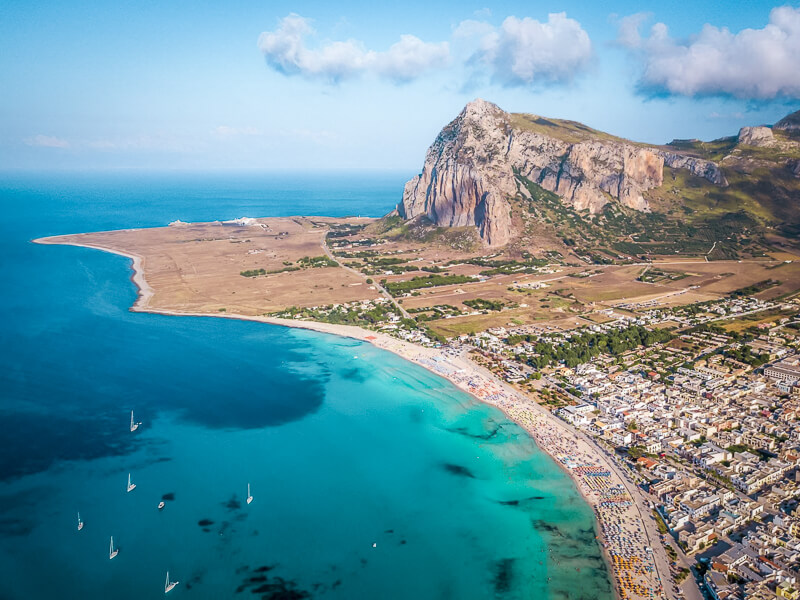 An aerial view of the beautiful San Vito Lo Capo beach with white sand and clear water, one of the best places on this Sicily itinerary