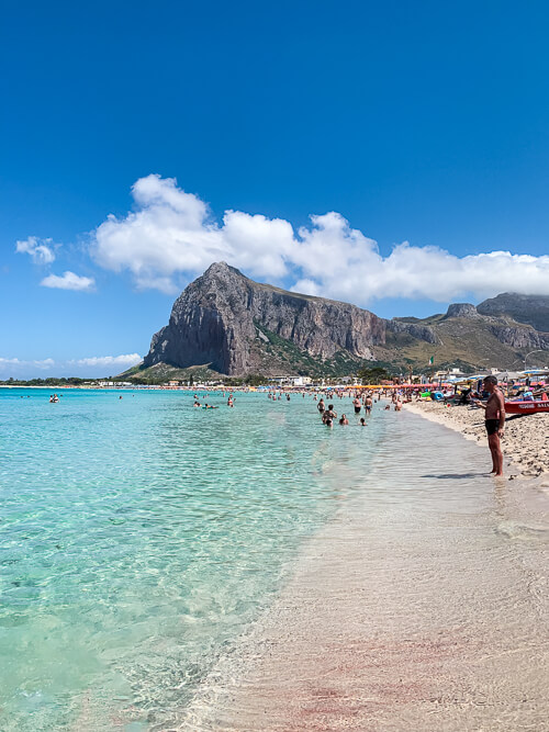 People enjoying the crystalline waters of San Vito Lo Capo beach.