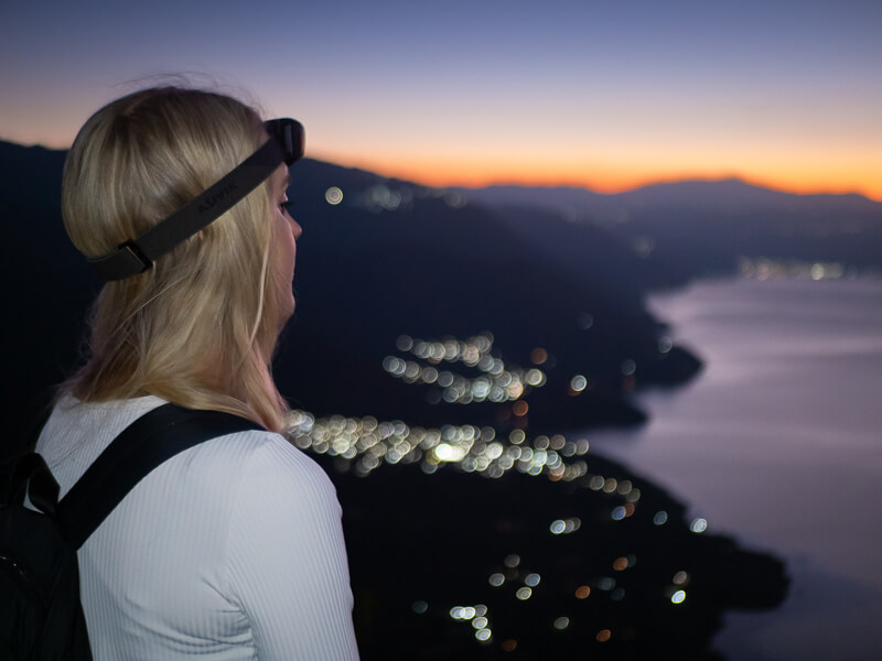 A woman gazing at the sunrise on the Indian Nose hiking trail in Guatemala
