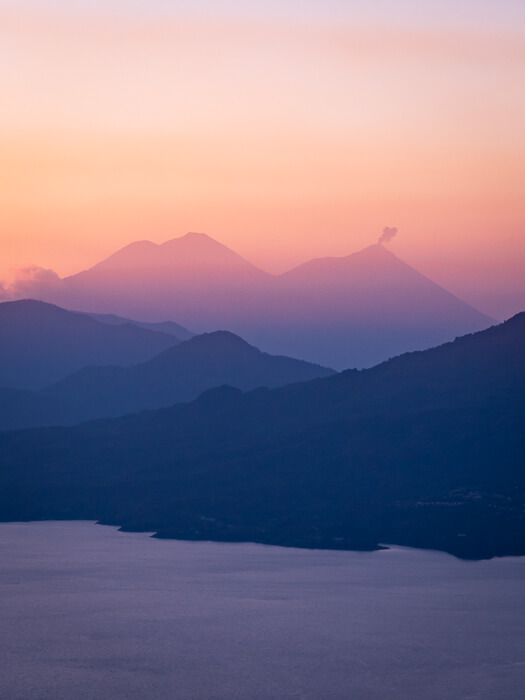 volcanoes against a pink sky viewed from the Indian Nose hike viewpoint during sunrise