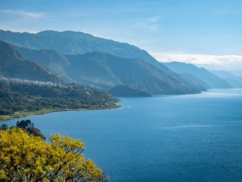 Lake Atitlan and its mountainous shores on a clear sunny day