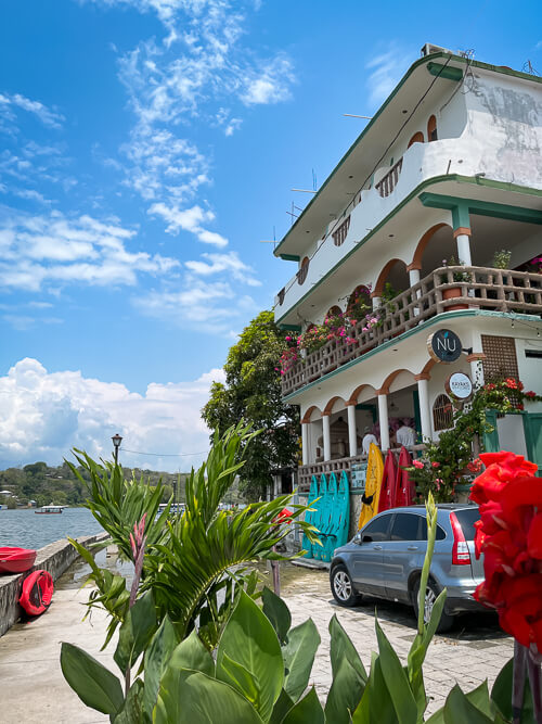 A white house decorated with colorful flowers in the town of Flores in northern Guatemala