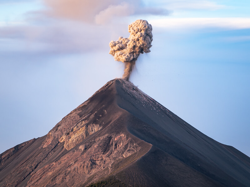 Fuego Volcano erupting and releasing a big column of ash into the sky