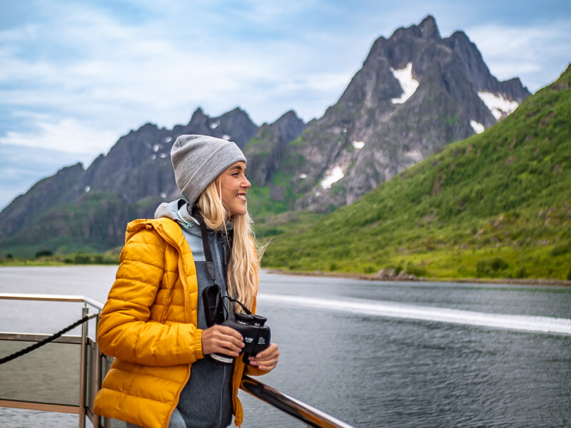 A woman gazing at the mountainous landscapes on a Silent Trollfjord Cruise in Norway