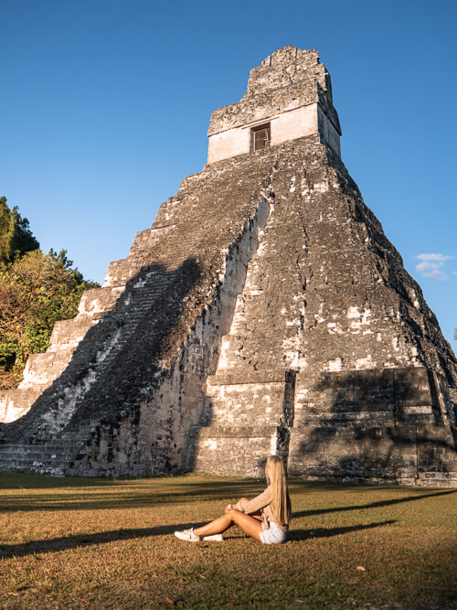Me sitting on the ground in front of the Mayan Temple of the Great Jaguar in Tikal National Park