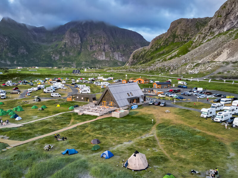 Tents, motorhomes and campervans parked at Lofoten Beach Camp, one of the best places to stay when traveling by campervan in Lofoten